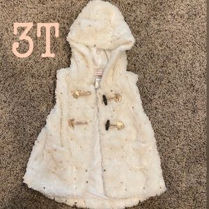 Plush toddler vest , cream in color.